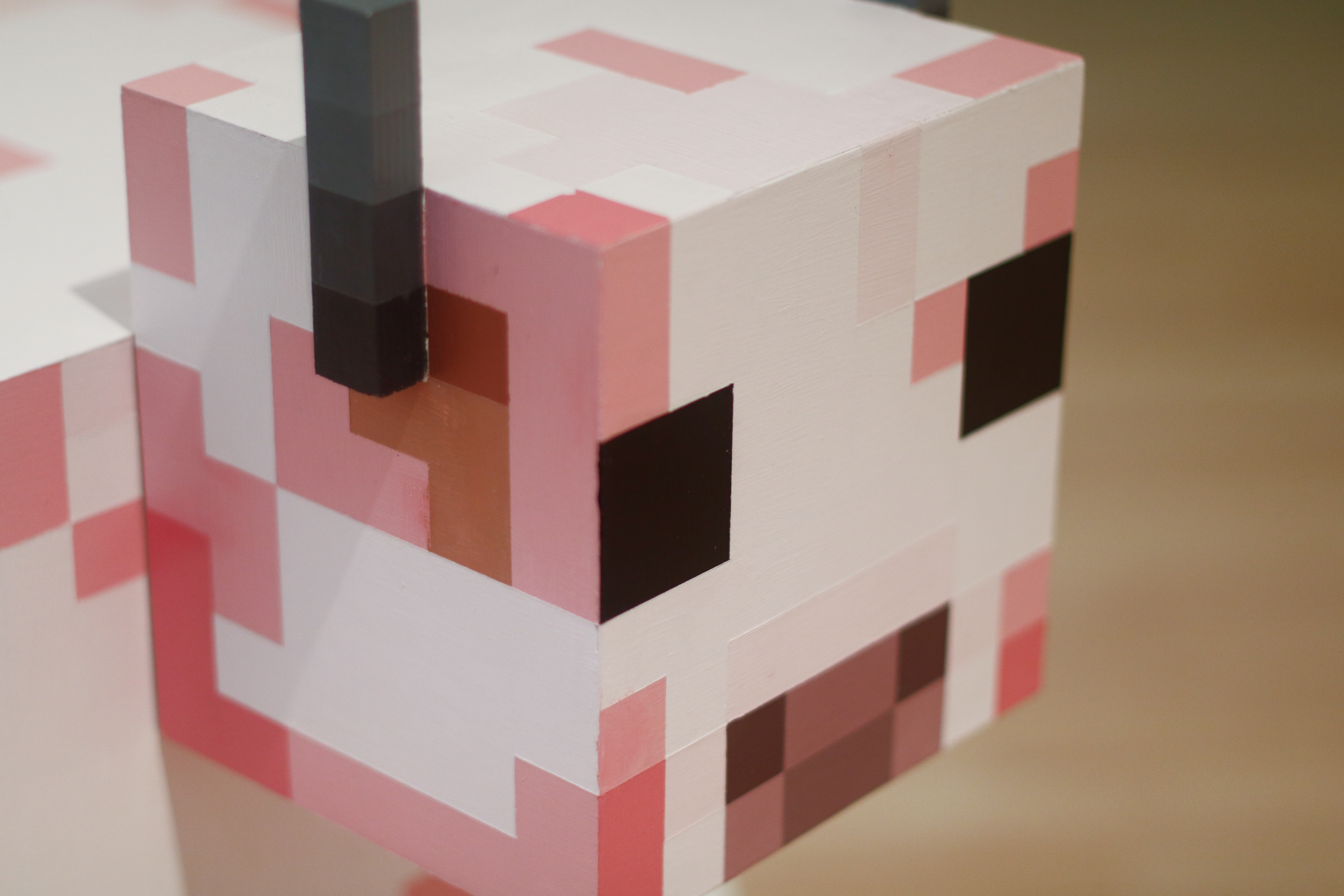 Details of pink Minecraft cow side table head.